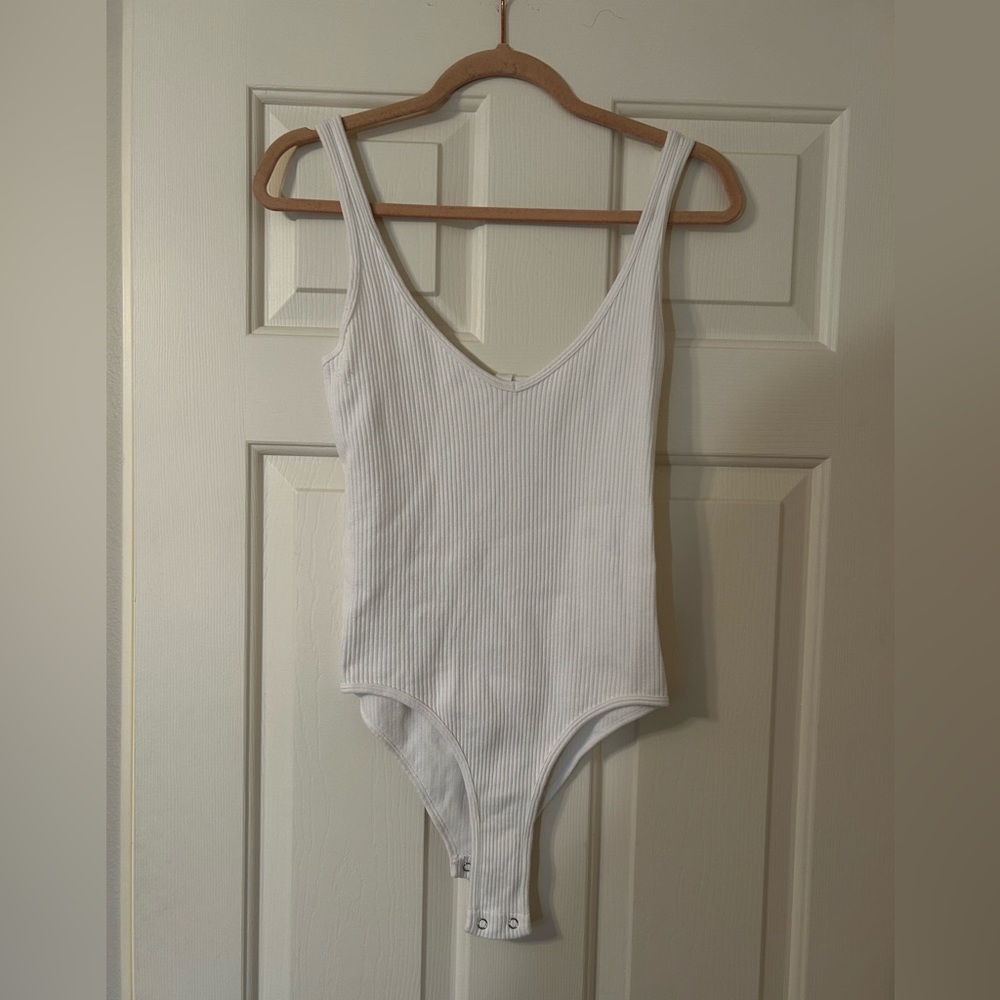 Ripped white tank top bodysuit